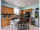 Modern kitchen with a center island, stainless steel appliances, and ample cabinet space at 3507 Portico Ln, Durham, NC 27703
