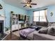 Open-concept living room with a fireplace, large TV, hardwood floors, and comfortable seating at 3507 Portico Ln, Durham, NC 27703