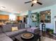 Living room with hardwood floors, a grey sectional couch, and an open view into the kitchen at 3507 Portico Ln, Durham, NC 27703