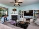 Comfortable living room featuring a fireplace, entertainment center, hardwood floors, and large windows at 3507 Portico Ln, Durham, NC 27703