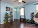 Bright living room featuring hardwood floors, a ceiling fan, decor, and a front door at 3507 Portico Ln, Durham, NC 27703