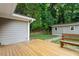 View of the wooden back deck with a wooden bench, providing an outdoor living space at 3515 Luna Ln, Durham, NC 27705