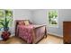 Cozy bedroom with hardwood floors and a decorative red bedspread at 3515 Luna Ln, Durham, NC 27705