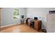 Bedroom with light wood flooring and an office setup near the window at 3515 Luna Ln, Durham, NC 27705