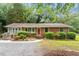 Lovely one-story brick home with mature landscaping and a charming front entrance at 3515 Luna Ln, Durham, NC 27705