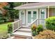 Charming front porch with double doors, and decorative plants and a small landing at 3515 Luna Ln, Durham, NC 27705