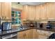 Updated kitchen featuring maple cabinets, modern backsplash, stainless steel appliances and natural light at 3515 Luna Ln, Durham, NC 27705