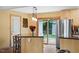 Well-lit kitchen with stainless steel appliances, eat-in breakfast bar, and access to an outdoor deck at 3515 Luna Ln, Durham, NC 27705