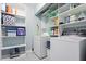 Bright laundry room with shelving, washer, and dryer at 3515 Luna Ln, Durham, NC 27705