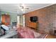 Inviting living room with brick wall, hardwood floors and decorative rug at 3515 Luna Ln, Durham, NC 27705