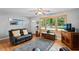 Inviting living room featuring large windows, a ceiling fan and a leather sofa at 3515 Luna Ln, Durham, NC 27705