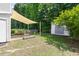 Backyard featuring a shade covering, dining table, a storage shed, and garden beds at 3634 Ranbir Dr, Durham, NC 27713