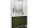 Updated half bathroom with modern fixtures, sink, and a round mirror at 3634 Ranbir Dr, Durham, NC 27713
