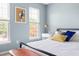 Comfortable bedroom featuring a large window, a bed, and soft blue walls at 3634 Ranbir Dr, Durham, NC 27713