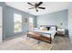 Bright bedroom with large windows, blue accent walls, and a ceiling fan at 3634 Ranbir Dr, Durham, NC 27713