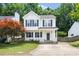Inviting two-story home with a covered front porch, green shutters, and a cozy, well-maintained yard at 3634 Ranbir Dr, Durham, NC 27713