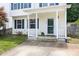 Close-up of front porch with white railings, a green door, and well-kept landscaping at 3634 Ranbir Dr, Durham, NC 27713