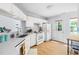 Charming kitchen featuring white cabinets, bright countertops, and a door to the backyard at 3634 Ranbir Dr, Durham, NC 27713