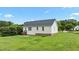 Rear exterior shot with level backyard, showcasing a door and windows in a serene setting at 3803 Ridgewood Dr, Franklinton, NC 27525