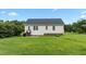 Rear exterior view of home with a backyard, featuring a door and windows surrounded by grass at 3803 Ridgewood Dr, Franklinton, NC 27525