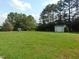 Expansive backyard with storage shed and playhouse, offering ample space for recreation and storage at 3803 Ridgewood Dr, Franklinton, NC 27525