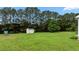 View of the backyard with a shed and large trees, showcasing a spacious outdoor area at 3803 Ridgewood Dr, Franklinton, NC 27525