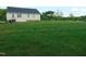 Large backyard features a spacious lawn and the exterior of the home, ideal for outdoor activities at 3803 Ridgewood Dr, Franklinton, NC 27525
