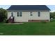 Exterior view of the back of house showing siding, windows, door, and well maintained lawn at 3803 Ridgewood Dr, Franklinton, NC 27525