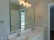 Well-lit bathroom featuring double sinks, large vanity mirror, and neutral tones for a calming aesthetic at 3803 Ridgewood Dr, Franklinton, NC 27525