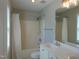 A bright bathroom showcasing a shower-tub combination, window and double sink vanity at 3803 Ridgewood Dr, Franklinton, NC 27525