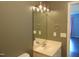 This bathroom has a single sink vanity with a mirror and towel rings at 3803 Ridgewood Dr, Franklinton, NC 27525