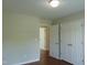 A spacious bedroom with hardwood floors and a large double door closet providing ample storage at 3803 Ridgewood Dr, Franklinton, NC 27525