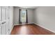 Cozy bedroom with hardwood floors, neutral walls, and a window at 3803 Ridgewood Dr, Franklinton, NC 27525