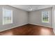 Bright bedroom with hardwood floors, ceiling fan, and large windows at 3803 Ridgewood Dr, Franklinton, NC 27525