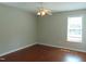 A bright bedroom featuring hardwood floors, a ceiling fan and a window offering ample natural light at 3803 Ridgewood Dr, Franklinton, NC 27525