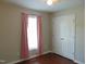 Bedroom features hardwood floors, window with pink curtains and a double door closet at 3803 Ridgewood Dr, Franklinton, NC 27525