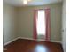 This bedroom features wood floors, a window with pink curtains, and a ceiling fan at 3803 Ridgewood Dr, Franklinton, NC 27525