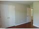 Bright bedroom featuring hardwood floors, a double door closet, and neutral walls at 3803 Ridgewood Dr, Franklinton, NC 27525