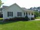 Charming single-story home with a welcoming front porch and neatly landscaped front yard with a well-maintained lawn at 3803 Ridgewood Dr, Franklinton, NC 27525