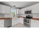 Well-lit kitchen featuring white cabinetry, butcher block counters, and stainless appliances at 3803 Ridgewood Dr, Franklinton, NC 27525