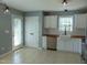 Bright kitchen with white cabinets, a farmhouse sink, stainless steel appliances, and tile flooring at 3803 Ridgewood Dr, Franklinton, NC 27525
