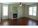 Spacious living room featuring hardwood floors, fireplace, large windows and neutral paint at 3803 Ridgewood Dr, Franklinton, NC 27525
