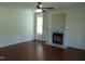 Bright living room with hardwood floors, a ceiling fan, a fireplace, and large windows at 3803 Ridgewood Dr, Franklinton, NC 27525