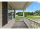 Relaxing front porch with white railings and a view of the green lawn at 3803 Ridgewood Dr, Franklinton, NC 27525