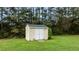 Close-up of the backyard shed with double doors, providing storage space and functionality at 3803 Ridgewood Dr, Franklinton, NC 27525