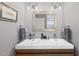Bathroom featuring double sink vanity with modern fixtures and a framed mirror at 409 E Lee St, Raleigh, NC 27601