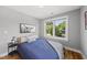 Cozy bedroom with hardwood floors, natural light, a comfortable bed and stylish decor at 409 E Lee St, Raleigh, NC 27601