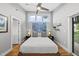 Bedroom with hardwood floors, a modern ceiling fan and abundant natural light at 409 E Lee St, Raleigh, NC 27601