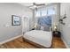 Bright bedroom featuring hardwood floors, a modern ceiling fan and abundant natural light at 409 E Lee St, Raleigh, NC 27601