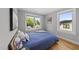 Cozy bedroom featuring natural light, hardwood floors, and a comfortable bed with a blue duvet at 409 E Lee St, Raleigh, NC 27601